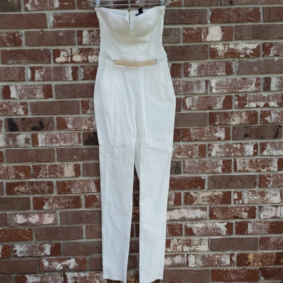 white jumpsuit with gold belt